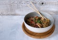 Udon bowl with chicken breast and vegetables top view with soy sauce and sicks. Asian food. Place for text Royalty Free Stock Photo