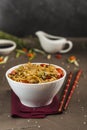 Udon noodles with chicken and vegetables in a plate with red chopsticks and soy sauce Royalty Free Stock Photo