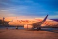 Thai Smile airline parking at the terminal during sunset at Udon Thani International Airport (UTH) in the northeast region of Thai