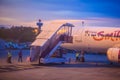 Thai Smile airline parking at the terminal during sunset at Udon Thani International Airport (UTH) in the northeast region of Thai