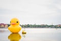 Yellow giant inflatable duck and yellow boat on the lake in Nong Prajak Park at night Royalty Free Stock Photo