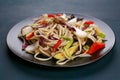 Udon wok noodles with pork and peppers, served on black plate, c Royalty Free Stock Photo