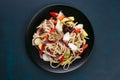 Udon wok noodles with pork and peppers, served on black plate, f Royalty Free Stock Photo