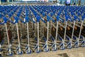 Ufa, Russia april 2, 2020: Airport trolley parking lot with empty trolleys and blue wall. Luggage carts at modern airport