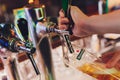 Ufa, Russia, 1 July, 2019: Heineken bartender poured beer into a glass.