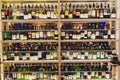 Ufa, Russia, 5 November, 2018: Closeup shot of wine shelf. Bottles lay over straw. Wine cellar.