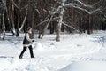 Old Woman Cross Country Skiing in Winter Forest Snow
