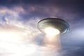 UFO with abduction beam flying in the sky Royalty Free Stock Photo