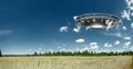 UFO, an alien plate hovering over the field, hovering motionless in the air. Unidentified flying object, alien invasion, Royalty Free Stock Photo