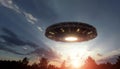 UFO, an alien plate hovering over the field, hovering motionless in the air. Unidentified flying object, alien invasion, Royalty Free Stock Photo