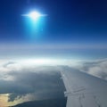 Ufo with bright blue spotlight flies near airplane in dark blue Royalty Free Stock Photo