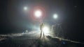 UFO concept. Glowing orbs, floating above a misty road at night. With a silhouetted figure looking at the lights