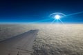 UFO flies near airplane in dark blue sky Royalty Free Stock Photo