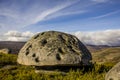 Isolated UFO-shaped granite rock with many tafoni on top of a mountain Royalty Free Stock Photo