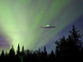 UFO spaceship with aurora sky and green alien on the ground