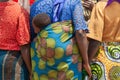 african woman colorful clothings carrying baby