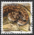 Uganda - CIRCA 1995: African rock python stamp of Uganda, circa 1995 Royalty Free Stock Photo