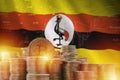 Uganda flag and big amount of golden bitcoin coins and trading platform chart. Crypto currency
