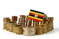 Uganda flag with stack of money coins