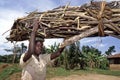 Ugandan girl carries firewood on her head