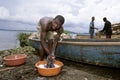 Ugandan man wash clothes at Lake Victoria, Uganda