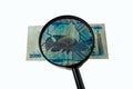 Ugandan shillings bill and magnifying glass