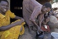 Ugandan woman washing a cooking pot, Gulu Royalty Free Stock Photo