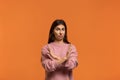 Ugh i won`t it. Portrait of serious woman in pink sweater, makes denial hand gesture, keeps arms crossed over chest, demonstrates Royalty Free Stock Photo