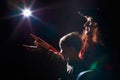 Ugle oman in red sweater and pirate hat with curly hair posing with small boy on black background. Actress mother and