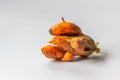 Ugly dirty deformed spoiled organic carrot on a white background with copy space. Food waste concept. Horizontal orientation