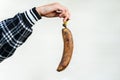 Ugly food. A rotten, spoiled banana in girl hand isolated on a white background.