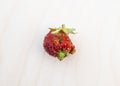 Ugly formless strawberry isolated on white background. Misshapen produce