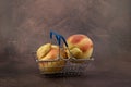 Ugly fruits concept. Deformed peaches in shopping basket. Reduce organic food waste. Last trend - Eating imperfect vegetables and Royalty Free Stock Photo