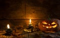 Ugly Halloween pumpkin head jack o lantern on wooden table background in a mystic  forest at night. Royalty Free Stock Photo