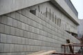 Ugly holding a road notch of a bridge forecourt tunnel. retaining wall with concrete grouting is covered with fake, optically pret Royalty Free Stock Photo