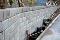 Ugly holding a road notch of a bridge forecourt tunnel. retaining wall with concrete grouting is covered with fake, optically pret Royalty Free Stock Photo