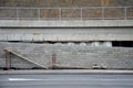 Ugly holding a road notch of a bridge forecourt tunnel. retaining wall with concrete grouting is covered with fake, optically pret Royalty Free Stock Photo