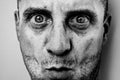 Ugly man portrait with unshaven face, dirty skin, big nose with black spots, terrific big eyes Royalty Free Stock Photo