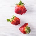 Ugly organic strawberries isolated on white background