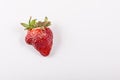 Ugly organic strawberries isolated on white background