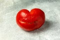 Ugly Organic Vegetable - Single red heart-shaped tomato on a gray background Royalty Free Stock Photo