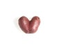 Ugly potato in the heart shape on a white background