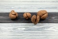 Ugly potatoes with deep cracks on a textured wooden background. Concept - unusual vegetables and fruits. Reduce the amount of