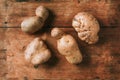 Ugly potatoes on wooden background. Ugly, unnormal vegetable, zero waste and plastic free concept. Top view. Copy space