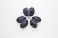 Ugly prunes. Three double plums fused together on a light background. Flat lay, top view, copy space. Concept - Food waste Royalty Free Stock Photo