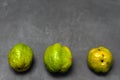 Ugly quince Chinese pear on a dark background is located at the bottom of the frame close-up