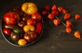 Ugly raf, kumato, heirloom tomatoes on brass tray, homegrown and fresh gathered and dried Physalis