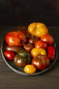 Ugly raf, kumato, heirloom tomatoes on brass tray, homegrown and fresh gathered.