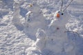 Ugly scary snowman made by children on a winter city street on the day of Christmas vacations