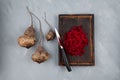Ugly vegetables of abnormal shape. Crooked funny beetroot on a brown chopping Board. Gray background, selective focus, copy space